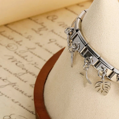 The Flower, Cross, Leaf & Bell Dangle Charm in Silver