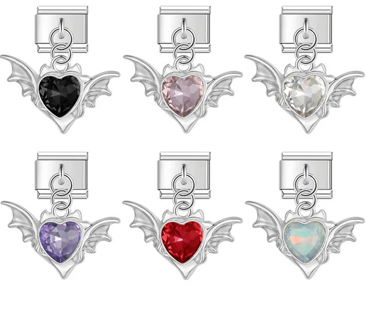 Set of heart-shaped charms with wing details in various colors o