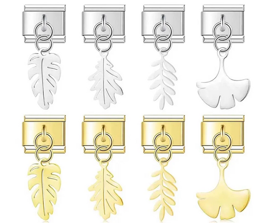 A set of 8 botanical leaf dangle Italian charms on silver and gold 9mm modular links featuring monstera, oak, fern, and gingko silhouettes - Charmtastic