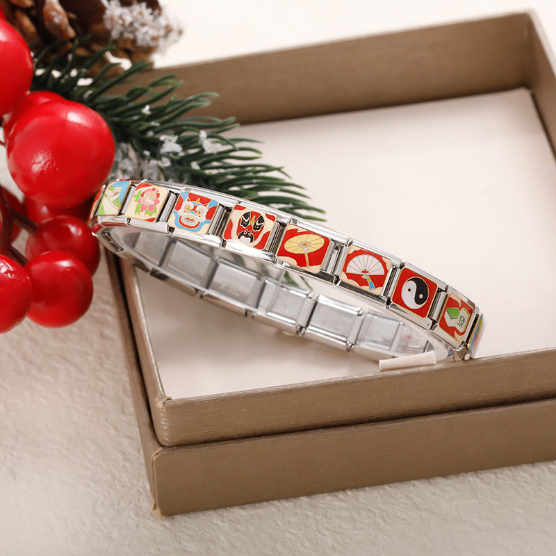 Chinese Heritage & Cultural Symbols Charms Tai Chi Kite – Italian charm bracelet displayed against an open gift box with pine branch and red berries, showing assorted Chinese cultural symbol charm links, Italian charm bracelet by Charmtastic