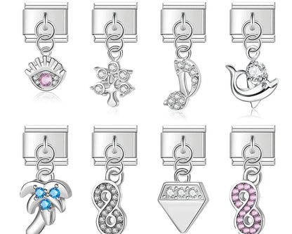 9mm silver Italian charm bracelet links featuring a pink crystal evil eye, a crystal tree of life, a music note, a dolphin, a blue crystal palm tree, clear and pink infinity symbols, and a crystal diamond dangle.