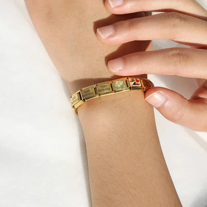 Feminine Beauty & Lifestyle Italian Charms – lifestyle photo of gold charm bracelet with birthday and floral charm links worn on a wrist, Italian charm bracelet by Charmtastic