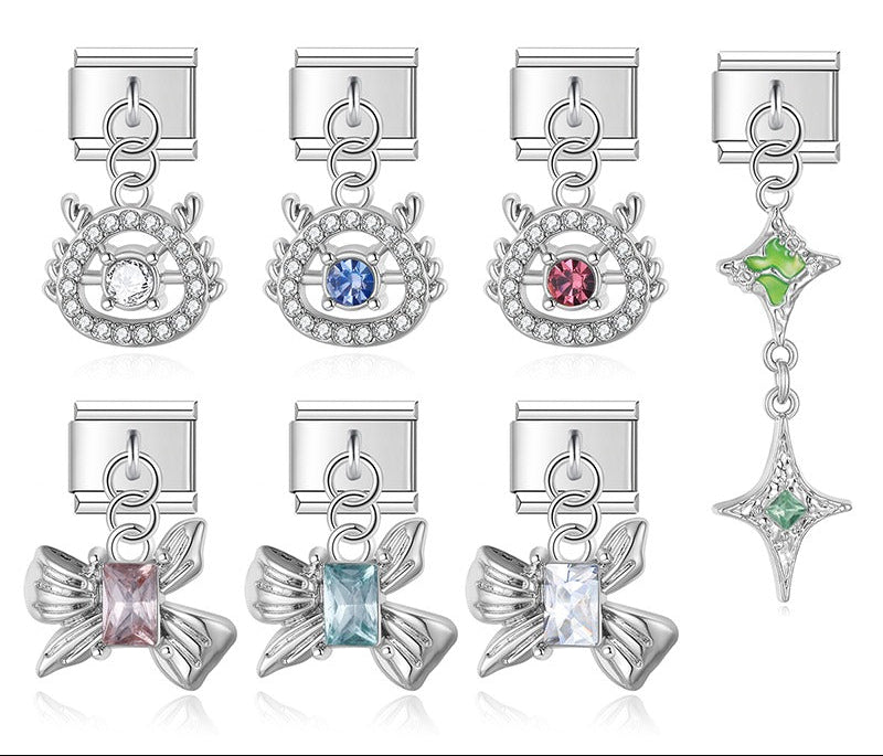 A collection of premium silver 9mm Italian charm dangles featuring rhinestone halos, sculpted metallic bows with rectangular gems, and a cascading green starburst.