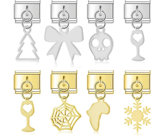A collection of 9mm Italian charm dangles featuring sleek metal cutouts including a skull, bow, spider web, wine glass, snowflake, tree, and map of Africa in silver and gold.