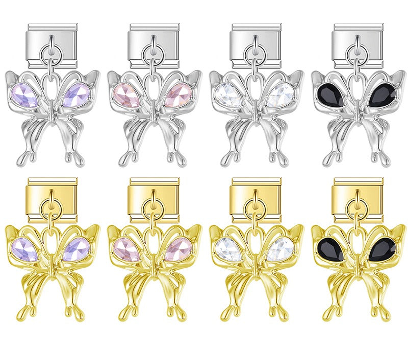 A 9mm Italian charm featuring a trendy, liquid-metal butterfly dangle accented with teardrop crystals. Available on silver and gold bases with purple, pink, clear, and black gems.