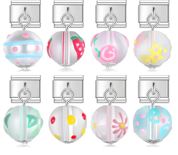 A collection of 9mm silver Italian charms featuring frosted glass bead dangles. Hand-painted designs include strawberries, florals, polka dots, stripes, and swirls.
