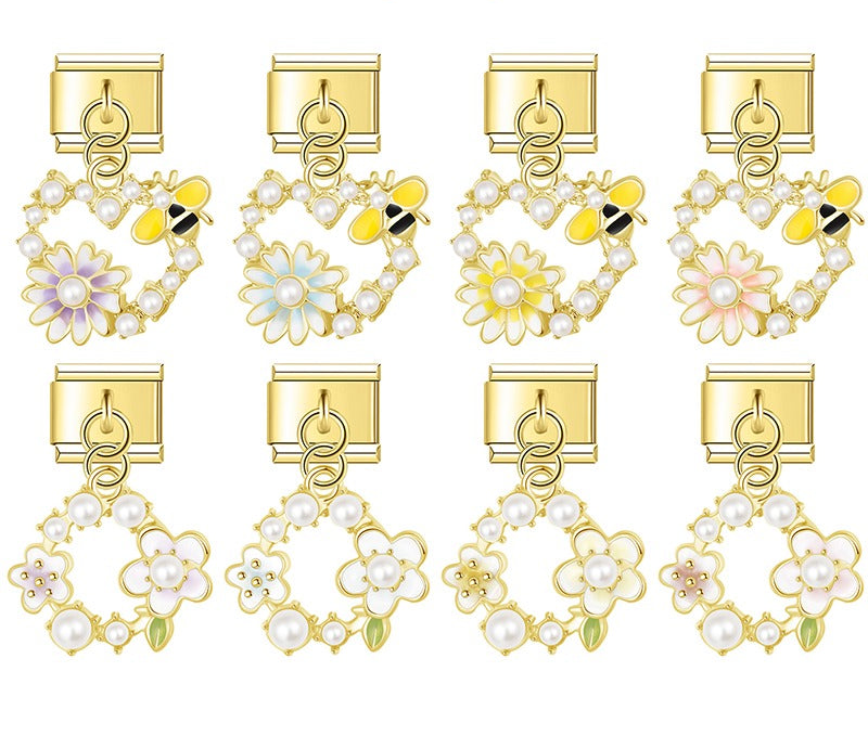 9mm gold Italian charm bracelet links featuring pearl-lined open hearts with bumblebees and daisies, plus pearl floral wreath dangles.