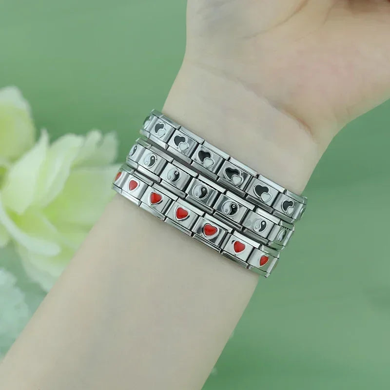 Silver charms bracelets with black designs – red and black heart Italian charm bracelets worn on wrist, by Charmtastic