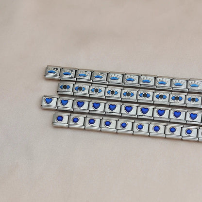 Silver charms bracelets with Blue designs Heart Round Star – blue crown, heart, and round stone Italian charm bracelets flatlay, by Charmtastic